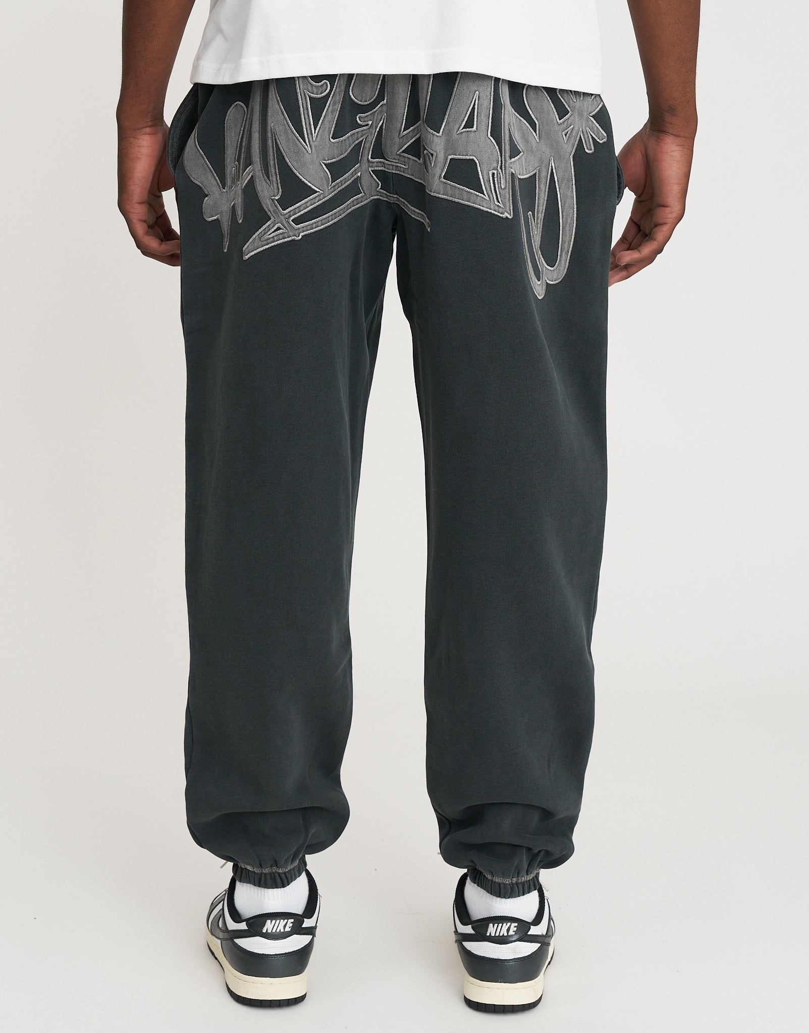 Vanguard Graffiti Baggy Track Pants in Washed Black | Hallensteins AU